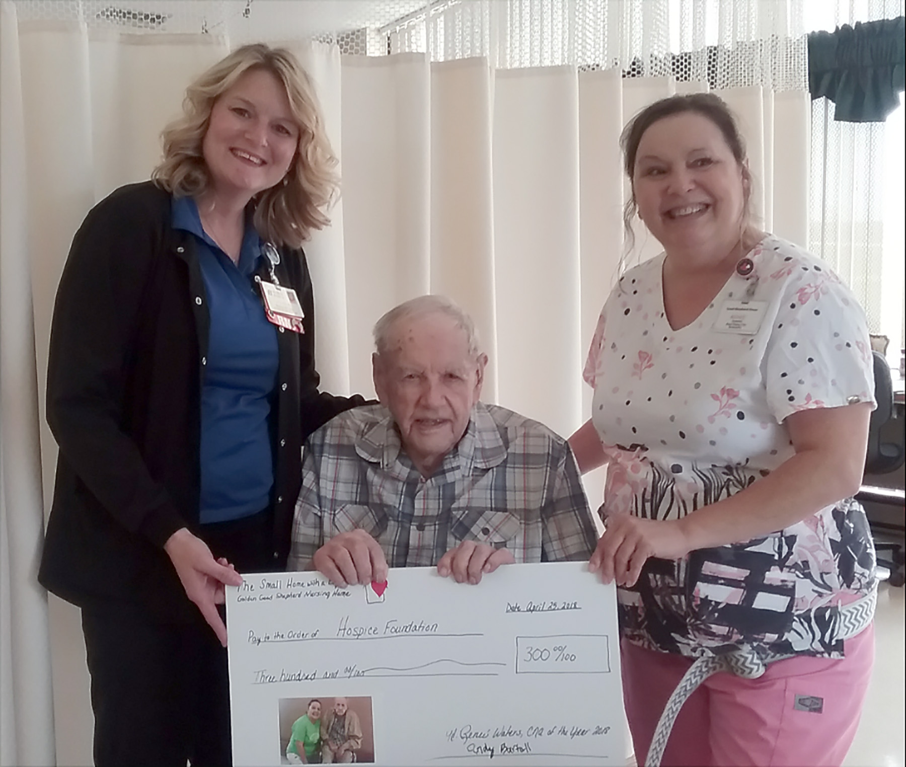 Melinda Thompson Blessing Hospice and 102 year old Andrew Bartell and Golden Good Shepherd Home CNA Renee Waters with $300 donation to Blessing Hospice