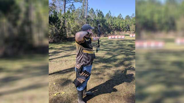 Alan Hurd shooting bow and arrow