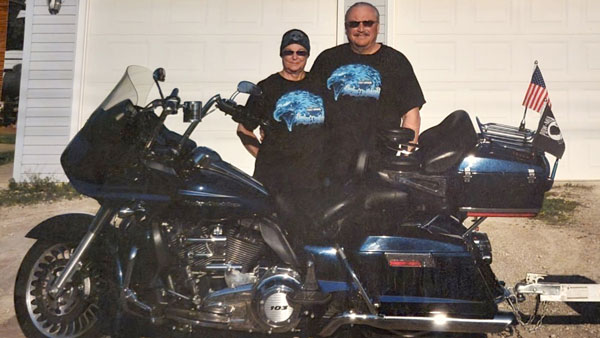 Bev Armstrong with her husband and their motorcycle