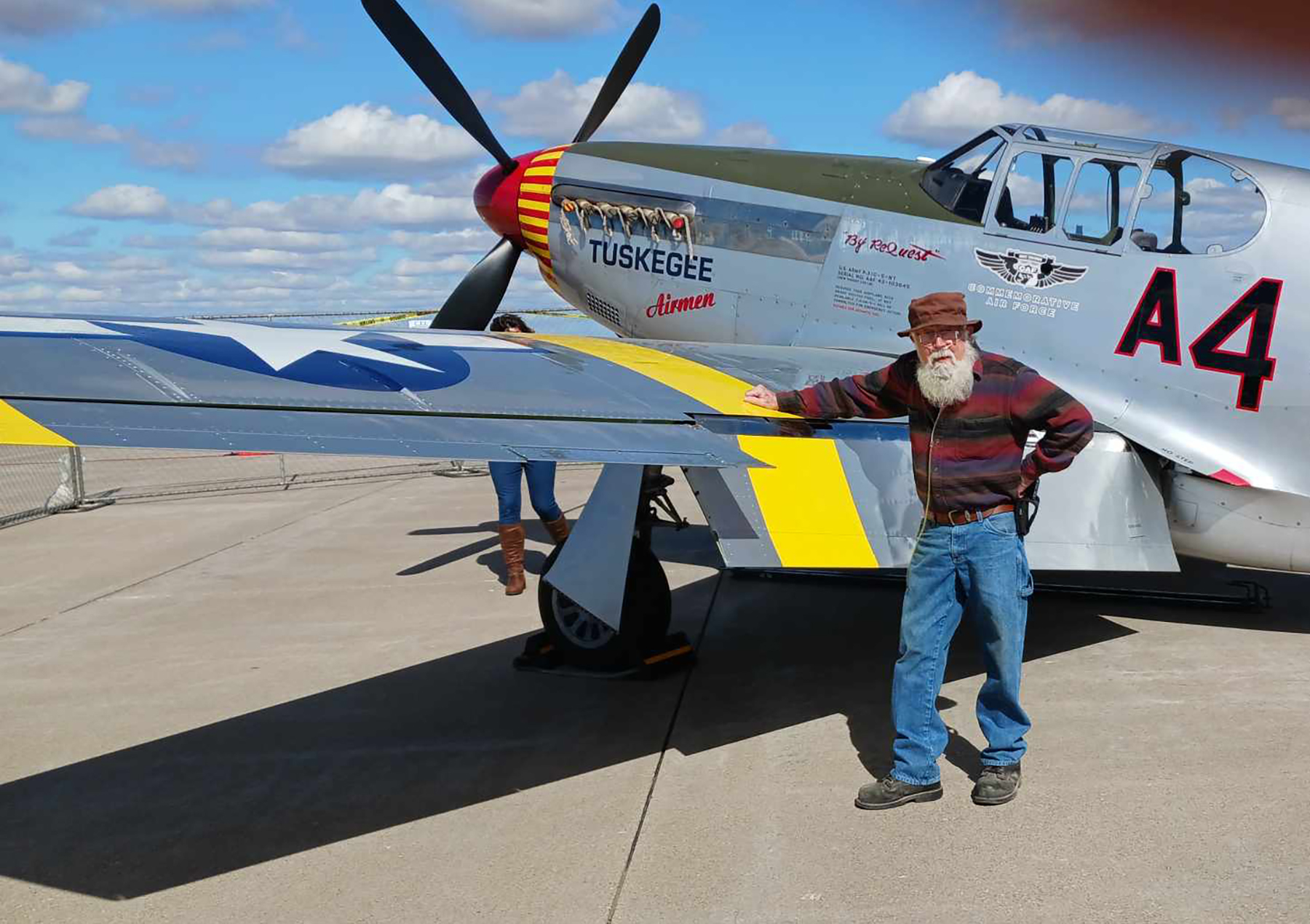 Blessing Hospital patient Robin Carel standing next to a  P51-C Mustang Red