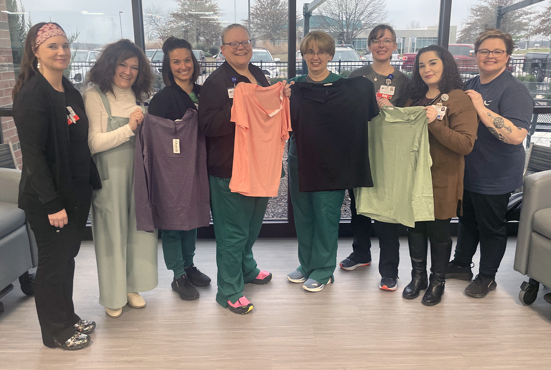 Team members displaying port shirts