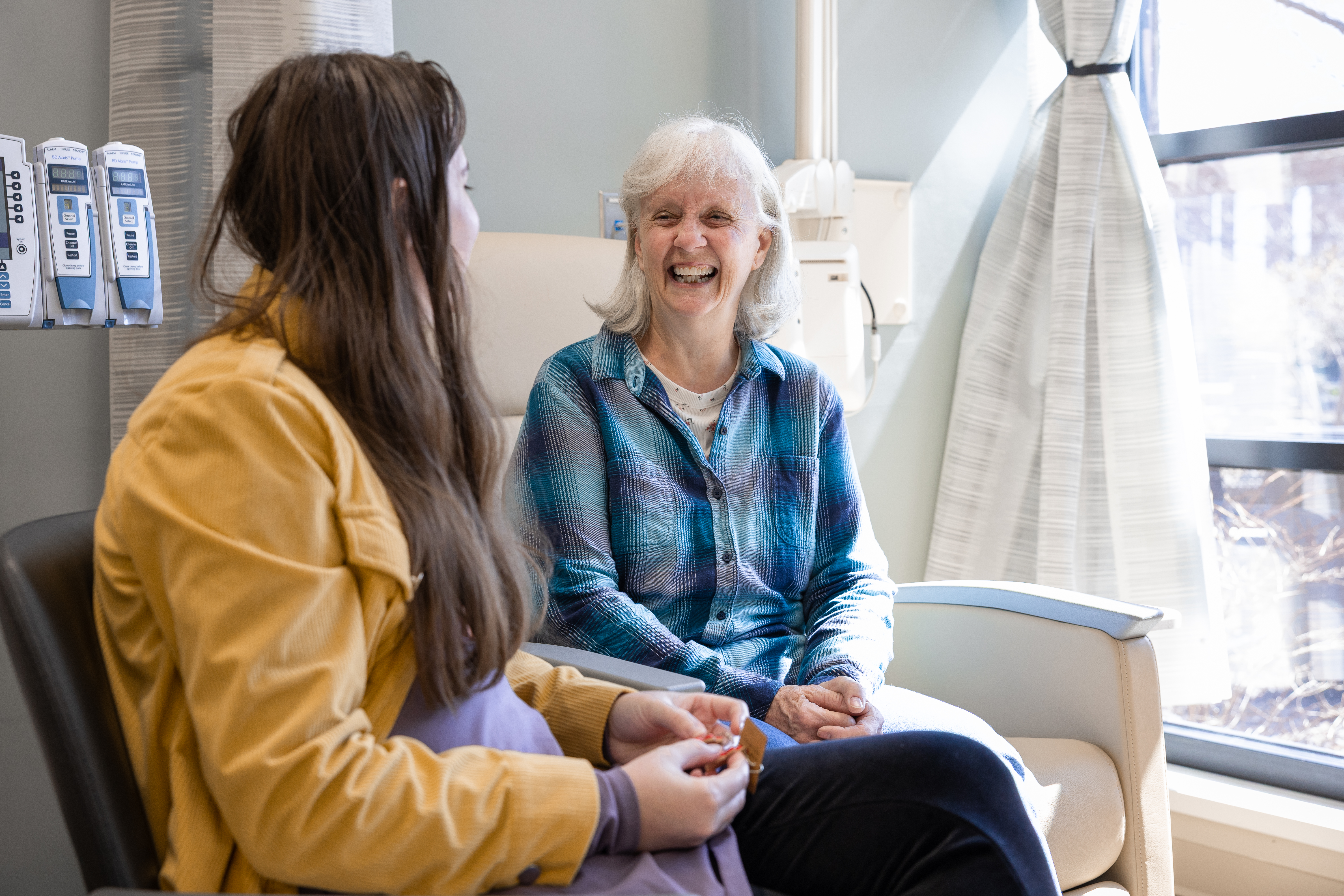 Marla Yates (right) and her daughter Megan (left) inspect handmade earrings created during Marla's chemotherapy treatments