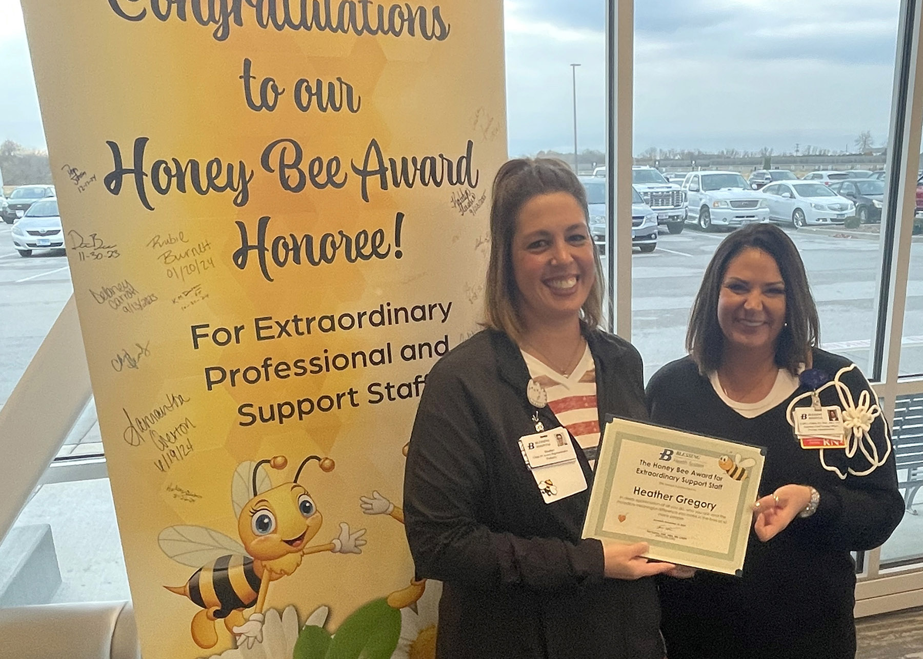 Heather Gregory accepts her Honey Bee Award from Karla Paris