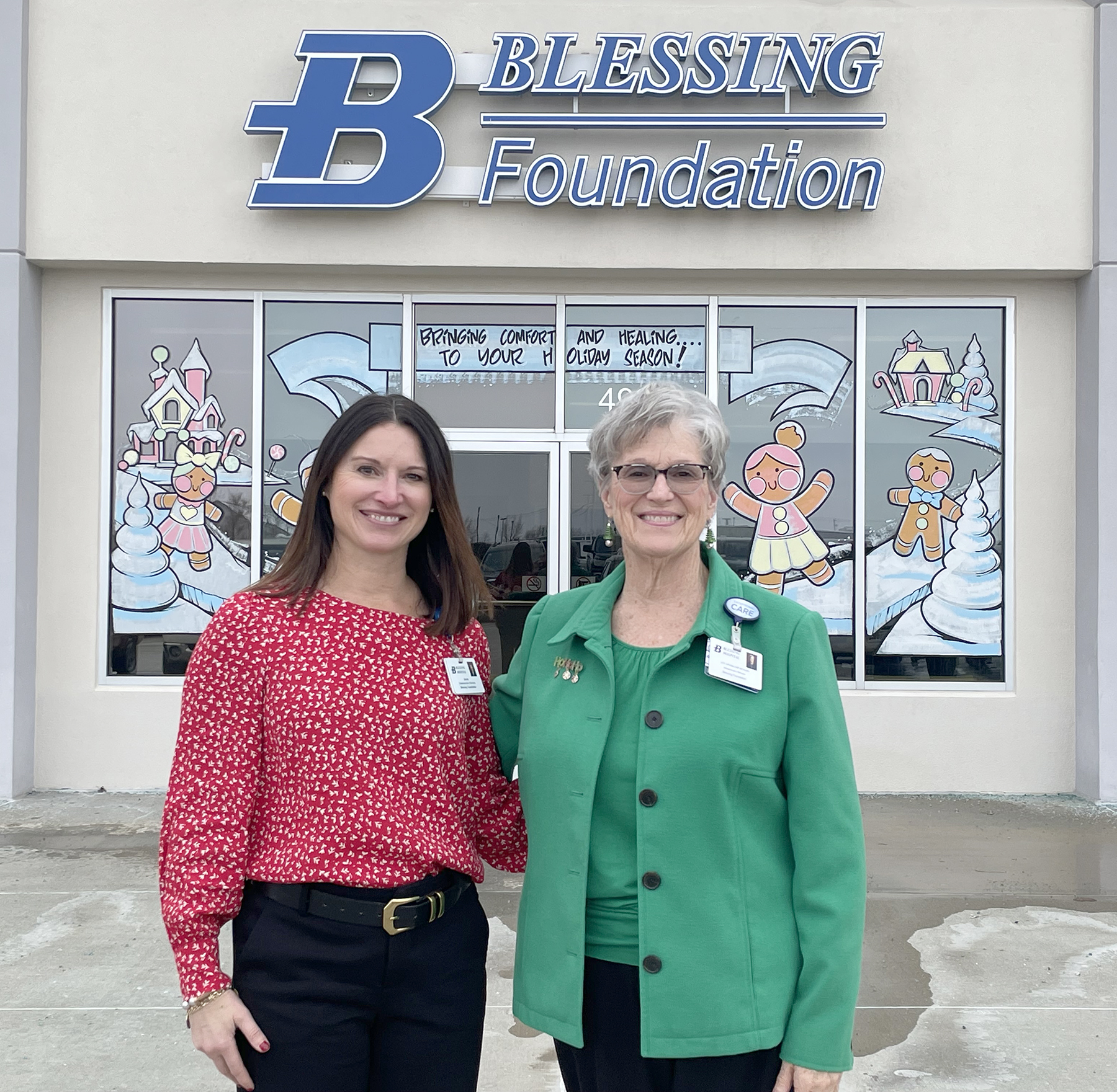 Jayme Connell and Ann Awerkamp-Dickson pose in front of the Blessing Foundation building.