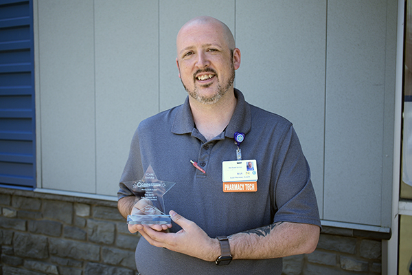 Ray Davis, lead pharmacy tech at Illini Health Services pharmacy in Pittsfield, earned the ICARE Award for Compassion at a surprise ceremony on Thursday, June 4.