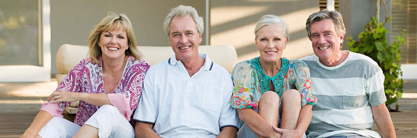 Mature Couples hanging out by pool