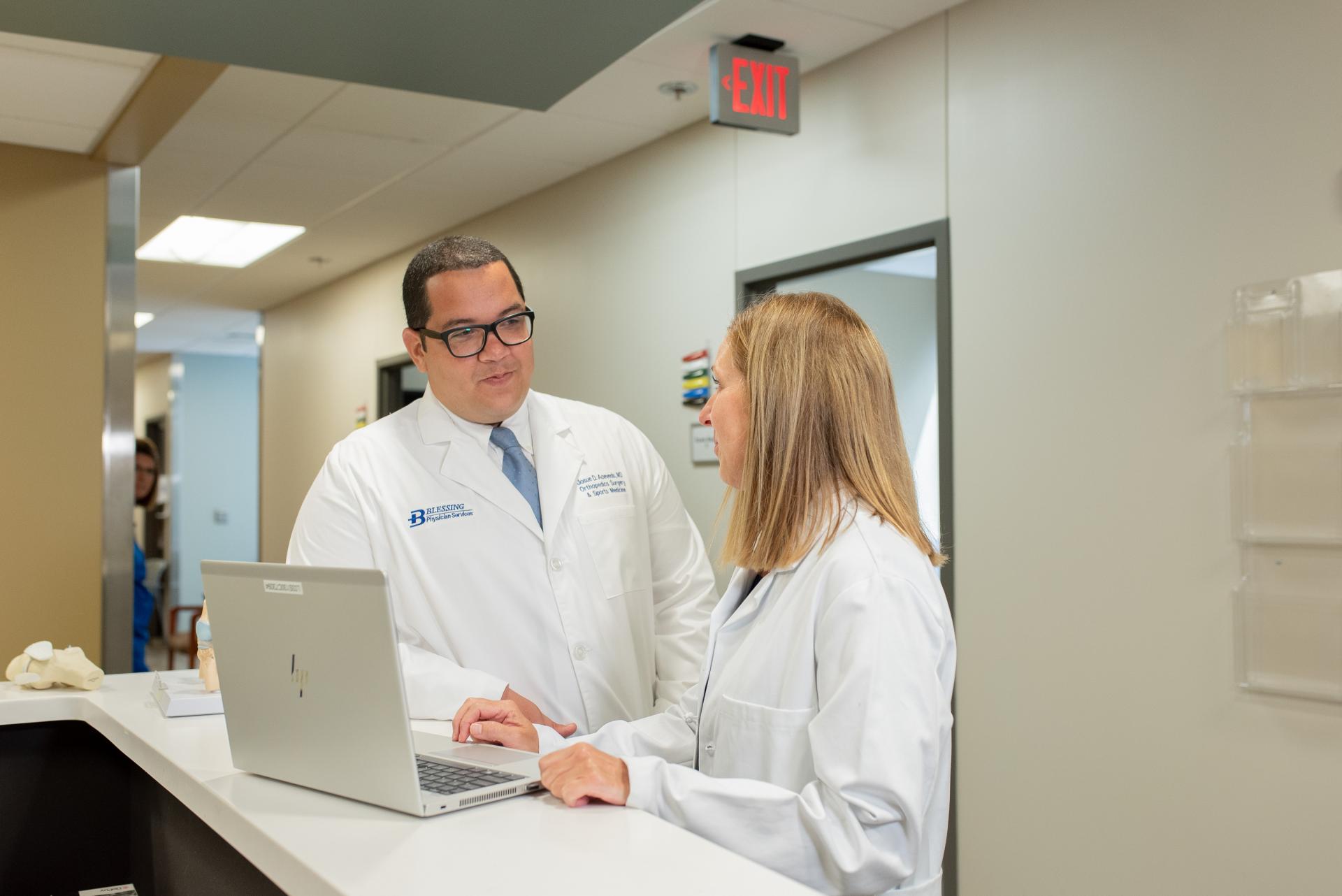 Dr. Acevedo consulting with colleague