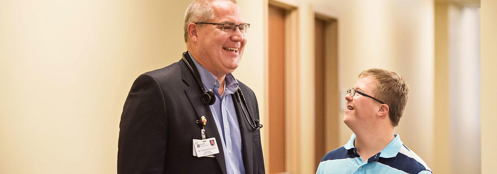 Dr. Beth talking to patient in hallway