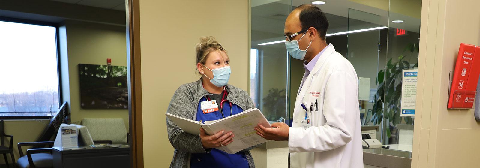 Dr. Junaid talking with nurse