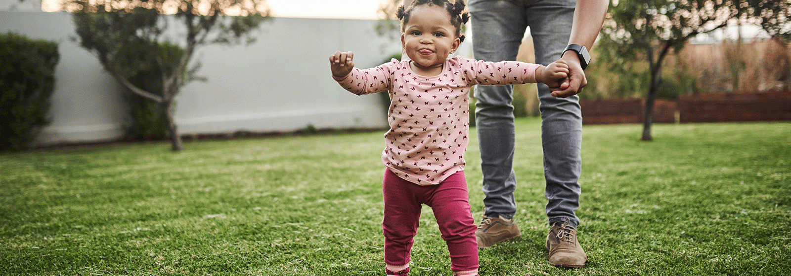 Little girl walking with adult