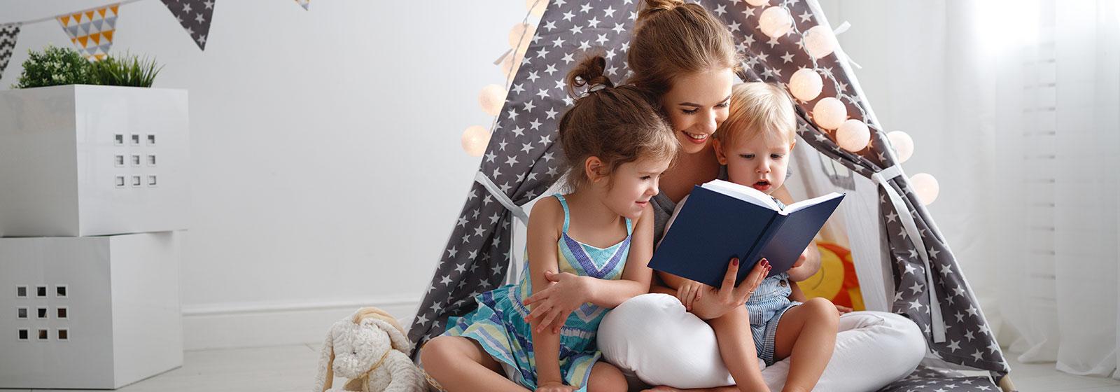 mom reading to kids in tent