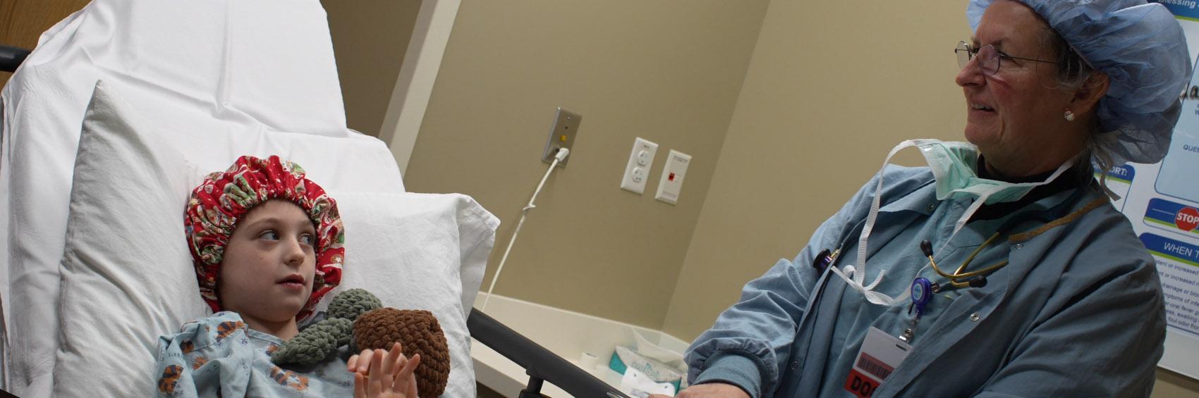 nurse talking with pediatric patient